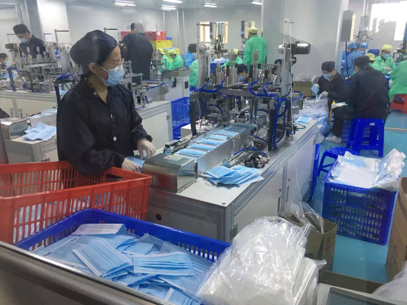 Workers on a mask production line in a Guangdong cleanroom during the 2020 shortage
